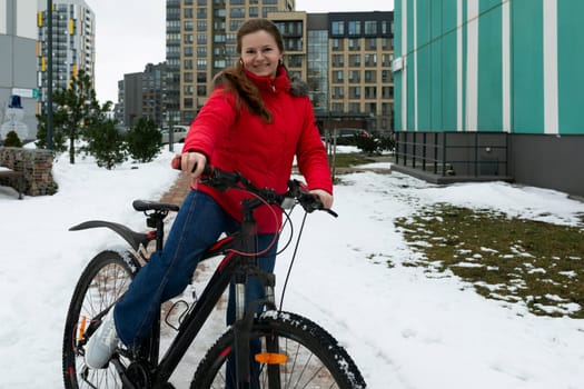 Caucasian woman rides a rented bicycle on a winter weekend.