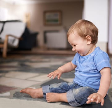 Growth, development and childhood for toddler in lounge for play and curiosity on floor. Baby, infant or kid at home with smiles and sitting with laugh and happiness for adorable and indoors.