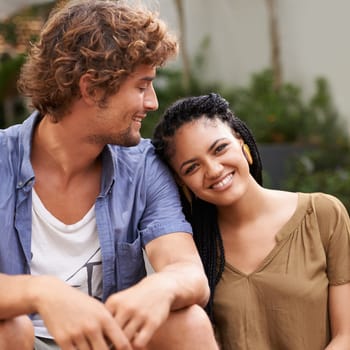 Diverse couple, outside and smile for bonding, park and date together in summer for boyfriend and girlfriend. Multiracial, male and female for nature, happy and love for outdoor of city life.