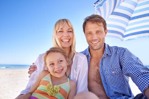 Family, beach and parents with child for travel, holiday in Sydney for summer and happy together. Man, woman and young girl in portrait with sea for adventure, trust and support with bonding outdoor.