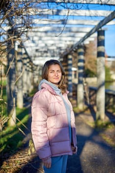 Winter Fun in Bitigheim-Bissingen: Beautiful Girl in Pink Jacket Amidst Half-Timbered Charm. Step into the festive winter spirit with this captivating image of a lovely girl in a pink winter jacket standing in the archway of the historic town of Bitigheim-Bissingen, Baden-Württemberg, Germany. The backdrop features charming half-timbered houses, enhanced by warm vintage photo processing, creating a delightful scene of winter joy and architectural beauty.