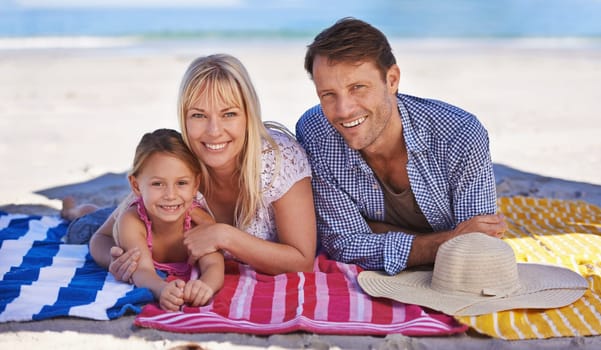 Portrait, smile and beach with family, holiday and summer with weekend break and getaway trip. Face, parents and mother with father or daughter with vacation and seaside with ocean or tropical island.
