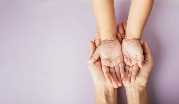 Family day concept, Parents and kid holding empty hands together on a color background. Celebrating togetherness and support.