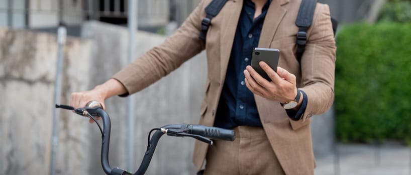 Businessman with bicycle using smartphone. man commuting on bike go to work. Eco friendly vehicle, sustainable lifestyle concept.