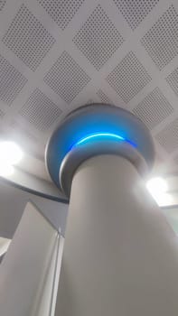 white column, interior design, structures inside, blue light lamp. High quality photo