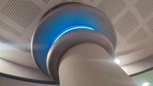 white column, interior design, structures inside, blue light lamp. High quality photo