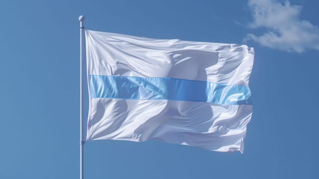 A white and blue flag flying in the wind against a clear sky
