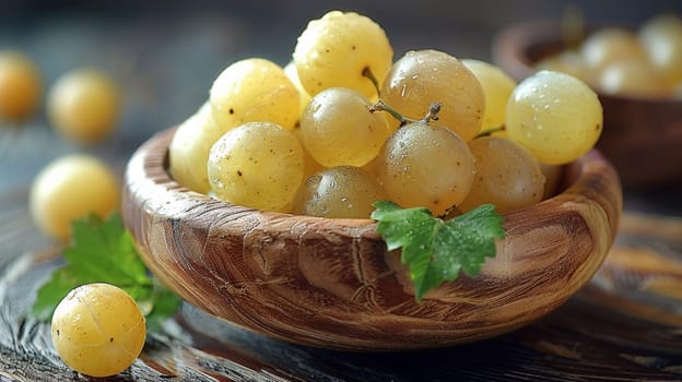 A bowl of grapes with a leaf on top sitting in the middle