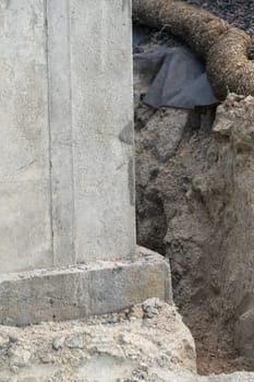 An ongoing construction site in the suburbs, featuring the foundation stage of a single-family house.