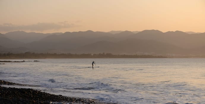 man doing SUP boarding on the Mediterranean Sea 7