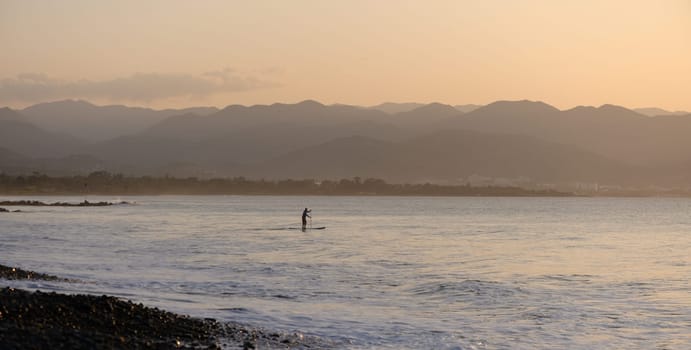 man doing SUP boarding on the Mediterranean Sea 9