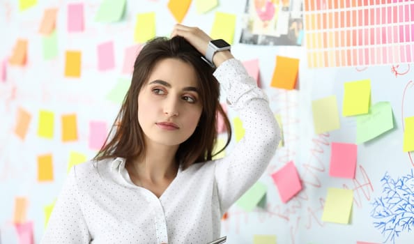 Pretty woman setting straight her hair at office workplace headshot