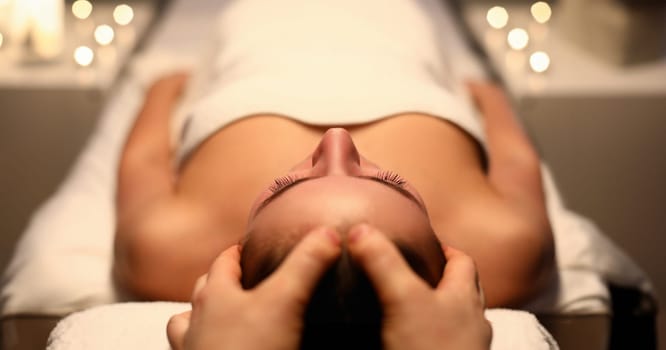Close-up of wonderful woman relaxing massage on spa treatments in salon. Beautiful female person enjoying in beautician. Beauty and relaxation concept