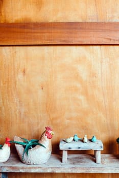 Still life image of Wooden bench and small birds with plant pot on wooden background.