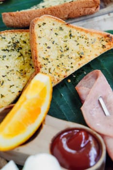 Breakfast with toast bread and ham on wooden tray