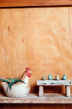 Still life image of Wooden bench and small birds with plant pot on wooden background.