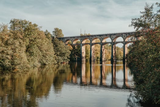 Railway Bridge with river in Bietigheim-Bissingen, Germany. Autumn. Railway viaduct over the Enz River, built in 1853 by Karl von Etzel on a sunny summer day. Bietigheim-Bissingen, Germany. Old viaduct in Bietigheim reflected in the river. Baden-Wurttemberg, Germany. Train passing a train bridge on a cloudy day in Germany