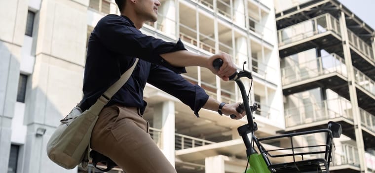 Young Asian businessman Go to work by cycling to reduce air pollution and stay healthy..