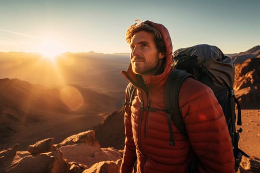 Man in orange jacket enjoying sunrise in mountains. Outdoor adventure and exploration concept for poster, wallpaper. Portrait with scenic nature backdrop and place for text