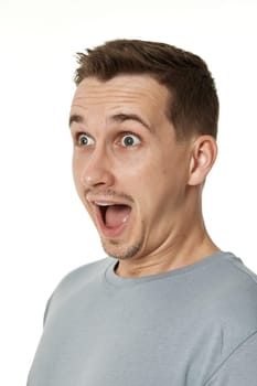 surprised guy looking at camera on white studio background