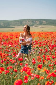 Woman poppies field. Side view of a happy woman with long hair in a poppy field and enjoying the beauty of nature in a warm summer day