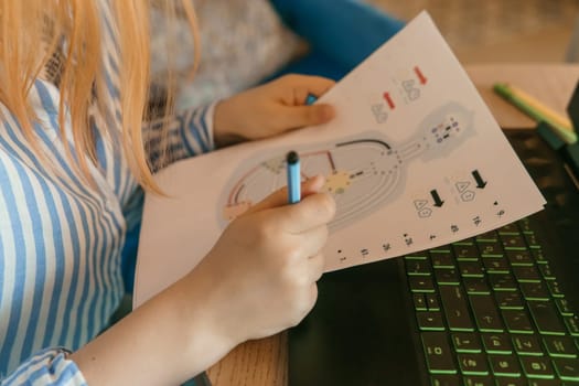 Tver, Russia-august 2, 2021. A woman in a cafe at a table with a laptop is studying the design of a person. The concept of studying esoteric sciences.