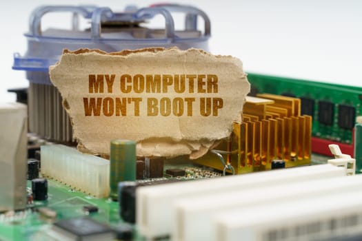On the computer motherboard there is a cardboard with the inscription - My computer won't boot up. Computer repair concept.