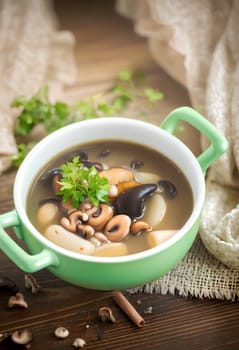 mushroom hot soup with beans in a bowl, on a rustic burlap tablecloth. AI generated image.