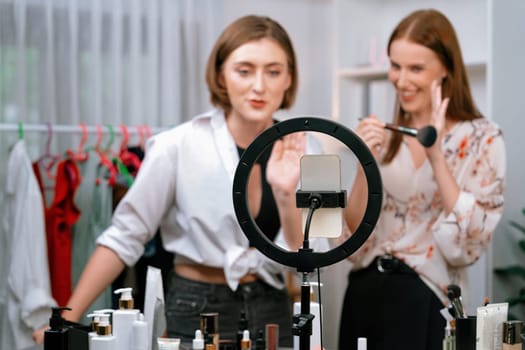 Woman influencer shoot live streaming vlog video review makeup utmost social media or blog. Happy young girl with cosmetics studio lighting for marketing recording session broadcasting online.