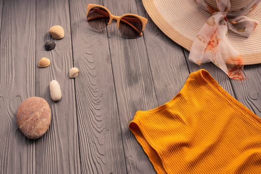 beachwear orange woman top outfit hat bag sun protection sunglasses pebbles. Summer background template mockup free space composition sample text. Top view above wooden background vacation concept