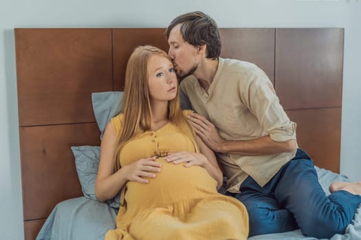 Expectant woman feels unwell, husband comforts and reassures her during a challenging pregnancy.