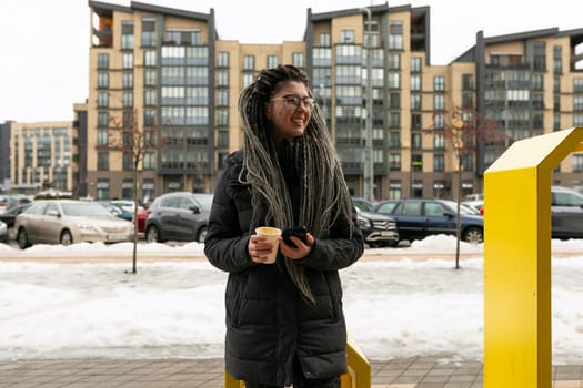 Cute young woman with dreadlocks hairstyle looks informal and unusual.