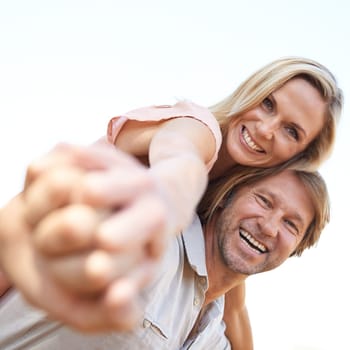 Happy, piggyback and portrait of couple in park hugging for love, care and marriage on vacation. Smile, outdoor and man and woman embracing in garden on holiday or weekend trip for romantic date