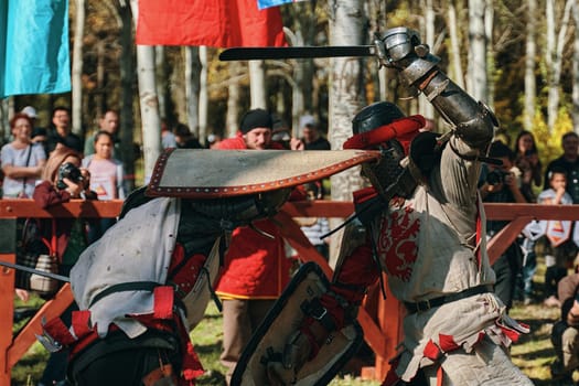 Imitation of medieval jousting. The battle of two knights with swords. Reconstruction of the historical tournament. Bishkek, Kyrgyzstan - October 13, 2019