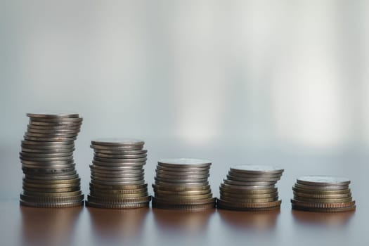 Table with stacked coins, symbolizing wealth, finance, and success in business and banking money, currency, and cash contribute to a growing pile, reflecting investment, savings, and financial growth