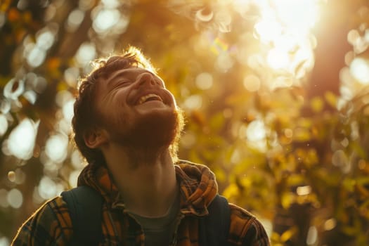 A young man smiles broadly, bathed in the warm, golden light of the setting sun. The autumn leaves create a vibrant bokeh, enhancing the feeling of happiness and contentment.
