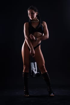 Sport fitness female in a white boxing gloves, studio shot