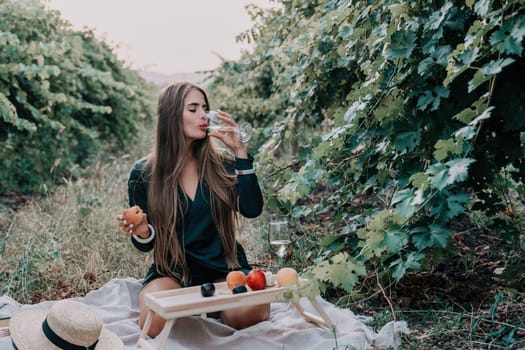 Picnic and wine tasting at sunset in the hills of Italy, Tuscany. Vineyards and open nature in the summer. Romantic dinner, fruit and wine.