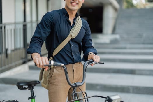 Businessmen ride bicycle to work to reduce carbon dioxide emissions and reduce global warming.