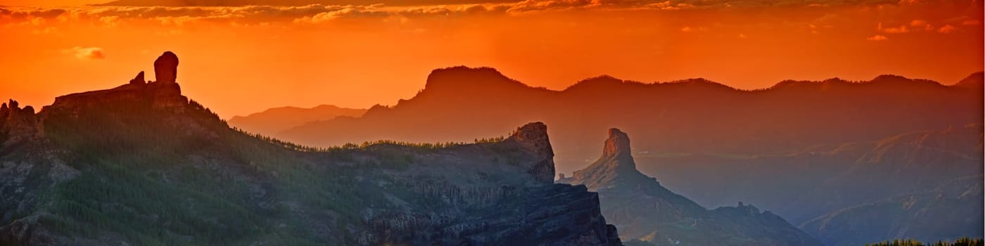 Landscape, sunset and panorama view of mountains, Gran Canaria Island with nature skyline and environment. Orange sky, horizon and natural background with travel location or destination in Spain.
