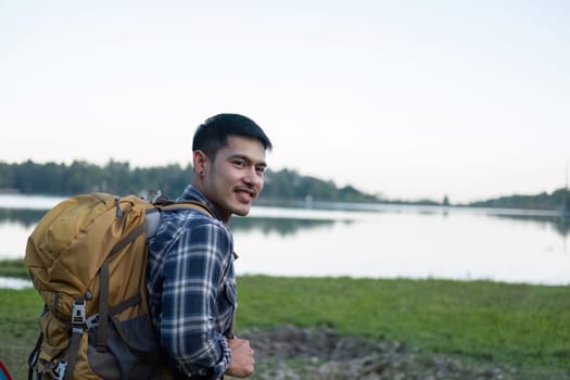 Asian tourist smiling happily Backpacker, hiking trips, outdoor activities on vacation..