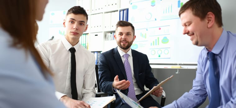 Bunch of businessmen sitting in office solving current problems portrait