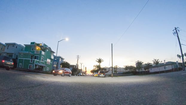 Los Angeles, California, USA-December 4, 2022-POV-As the sun sets, driving on HWY 101 near Pismo Beach, California becomes a captivating experience with the sky painted in shades of orange and pink, casting a warm glow over the coastal landscape.