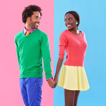 Fashion, smile and black couple holding hands in studio with colorful, trendy and stylish outfit. Happy, love and young African man and woman with edgy, classy and retro style by background