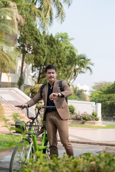 The businessman eco friendly transportation, cycling through the city avenues to go to work. sustainable lifestyle concept.