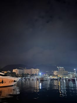 Yachts moored at the pier with high-rise buildings on the shore. High quality photo