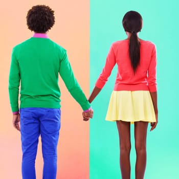 Couple, back and holding hands with fashion in studio, background and creative aesthetic. Together, woman and man with colorful style, unique clothes or people with support or trust in mockup space.