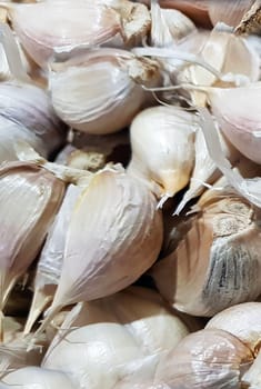 Garlic bulbs on black background, close-up. Organic garlic top view. Food background. Selective focus.