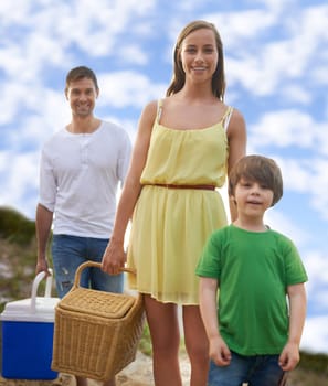Portrait, picnic and happy family on beach for holiday, adventure and tropical vacation in Australia. Mother, father and face of boy child relax at ocean with sunshine, weekend and smile in summer