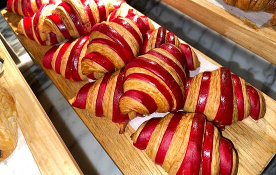 Close up of group of fresh baked delicious christmas croissants, super delicious warm fresh buttery Croissants and Rolls, French and American Croissants and baked pastries are enjoyed world wide on bakery shop, tasty multiple croissant